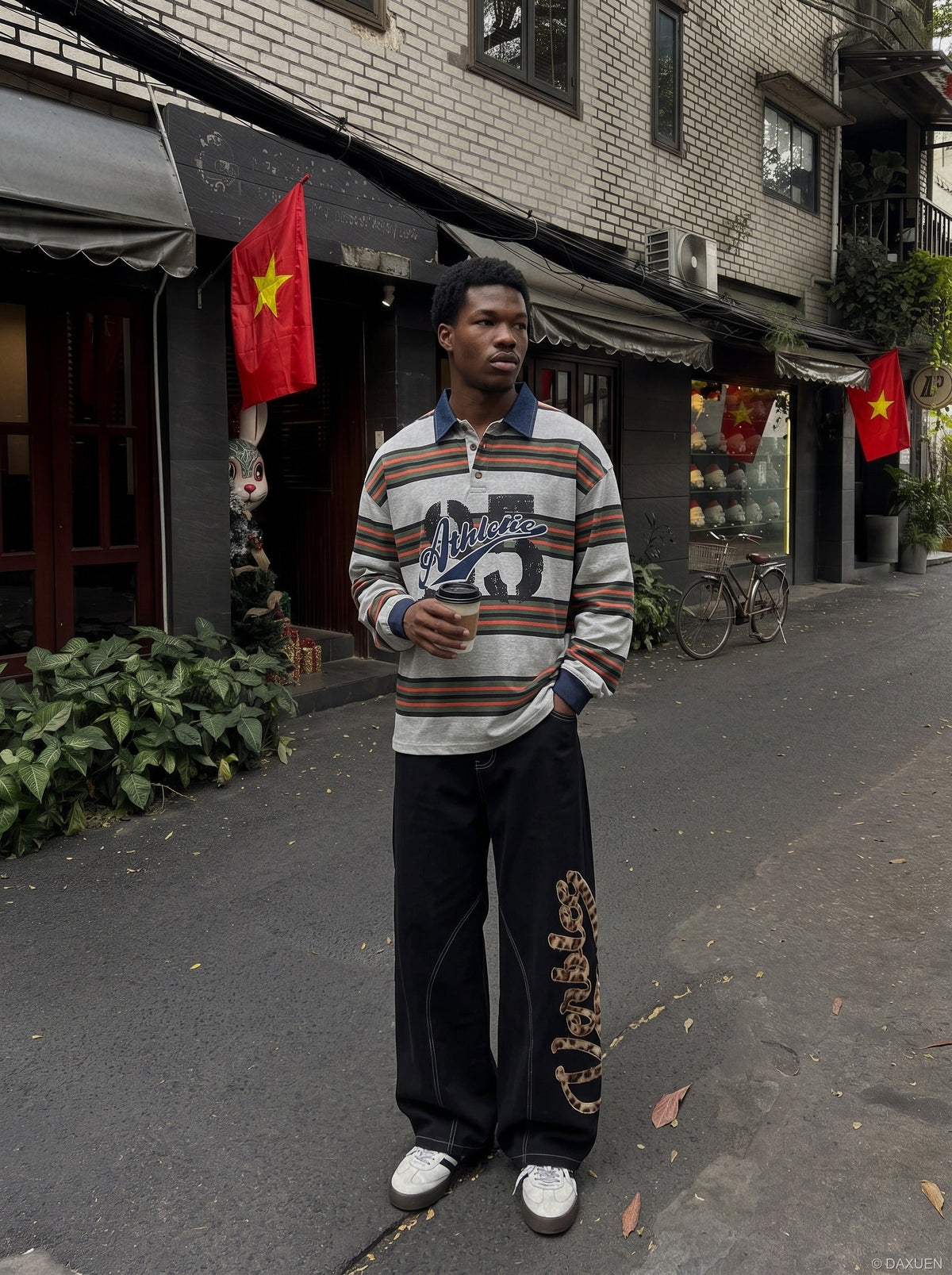 Oversized striped graphic polo shirt shown on a model from the back