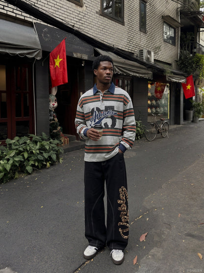 Oversized striped graphic polo shirt shown on a model from the back