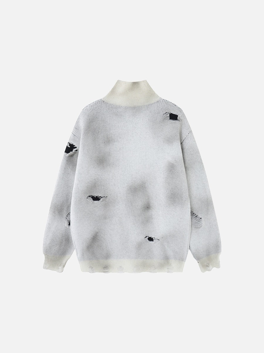 Knitted sweater featuring a prominent cross design