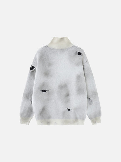 Knitted sweater featuring a prominent cross design