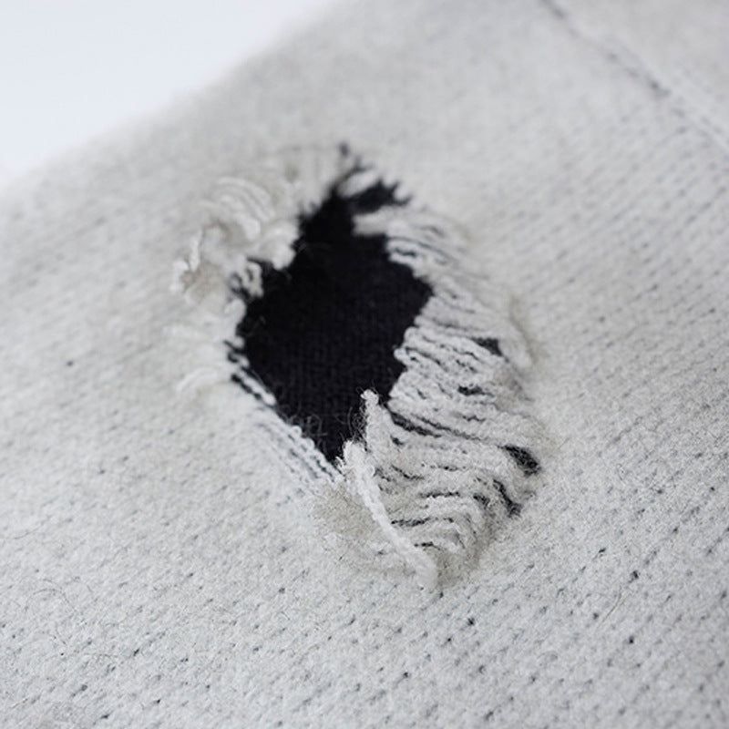 Close-up of the sweater neckline and cross graphic