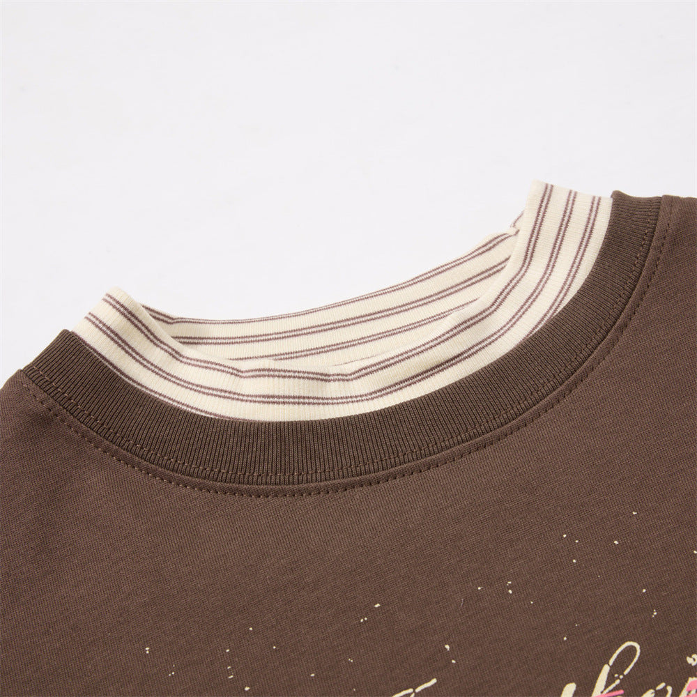 Full-length styling of oversized layered graphic T-shirt in pink