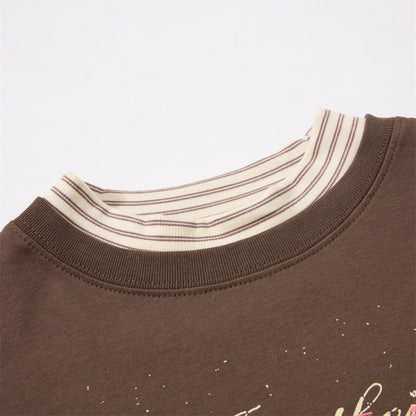 Full-length styling of oversized layered graphic T-shirt in pink