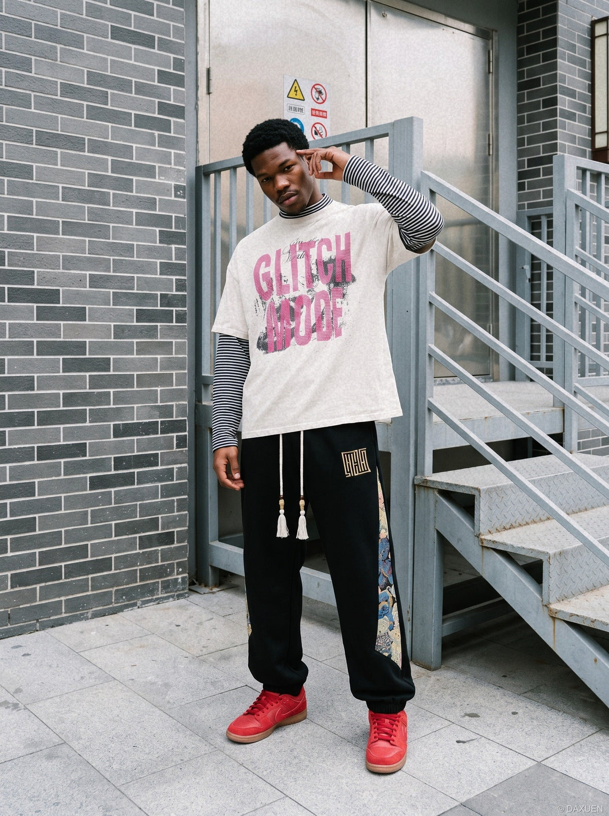 Close-up of block graphic on distressed pink layered T-shirt