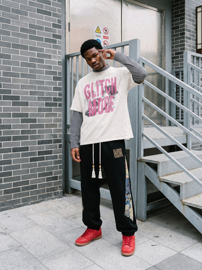 Close-up of block graphic on distressed pink layered T-shirt