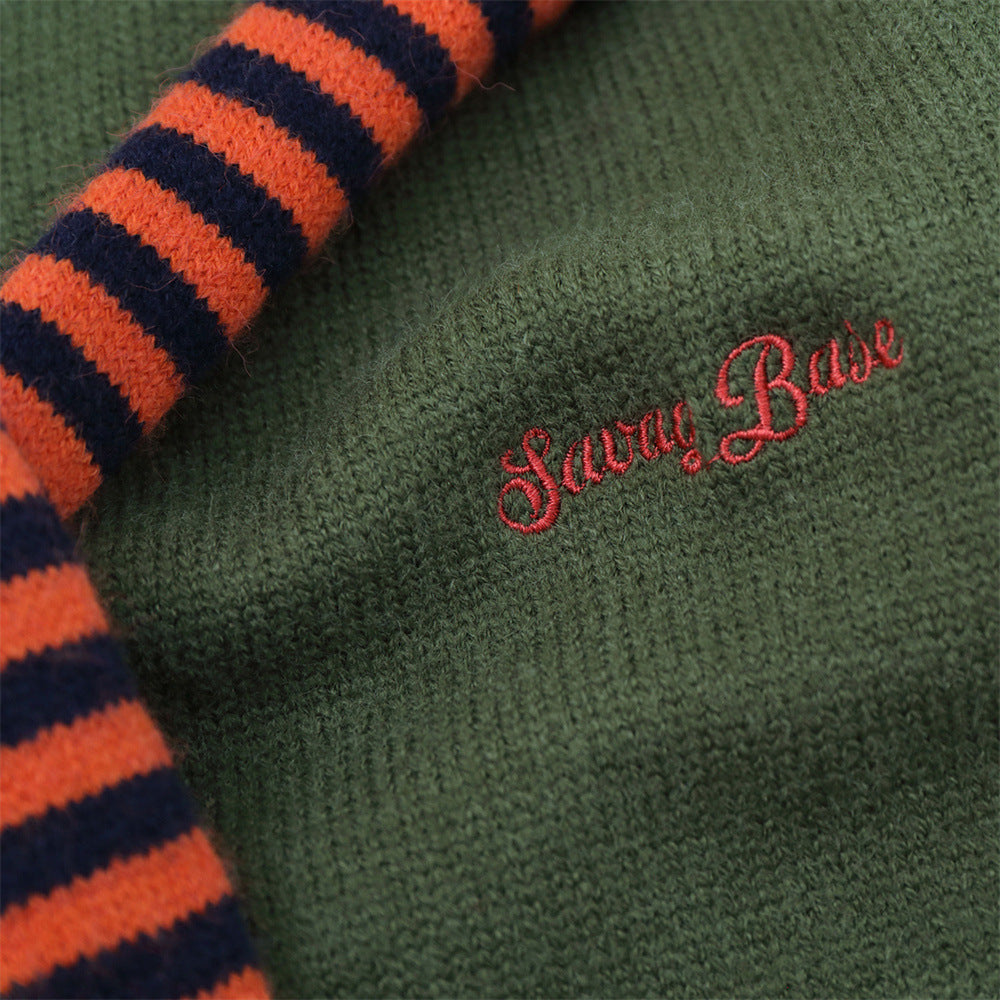 Draped neckline detail on an olive and navy knit sweater