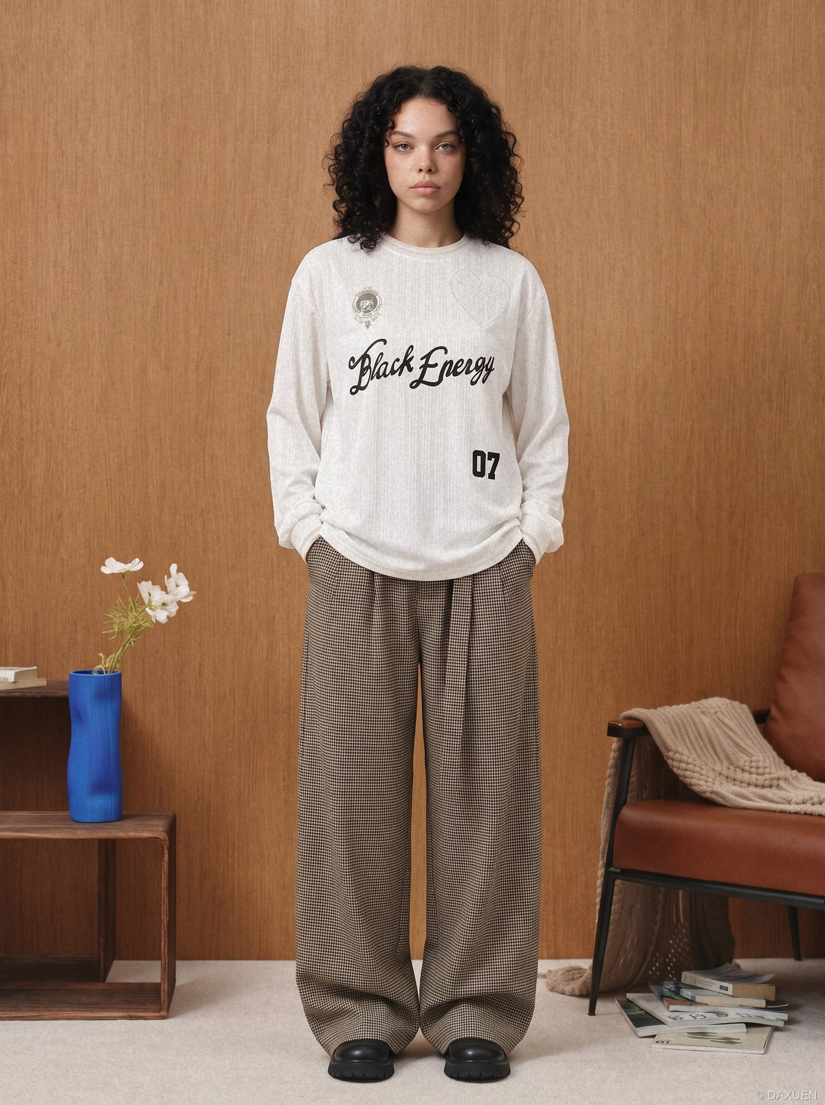 Model wearing oversized jersey T-shirt with embroidered crest