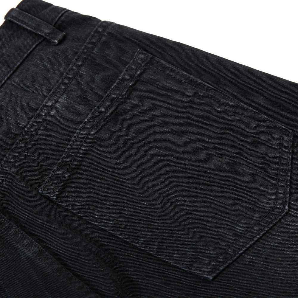 Detail of waistband and pocket on faded black denim shorts