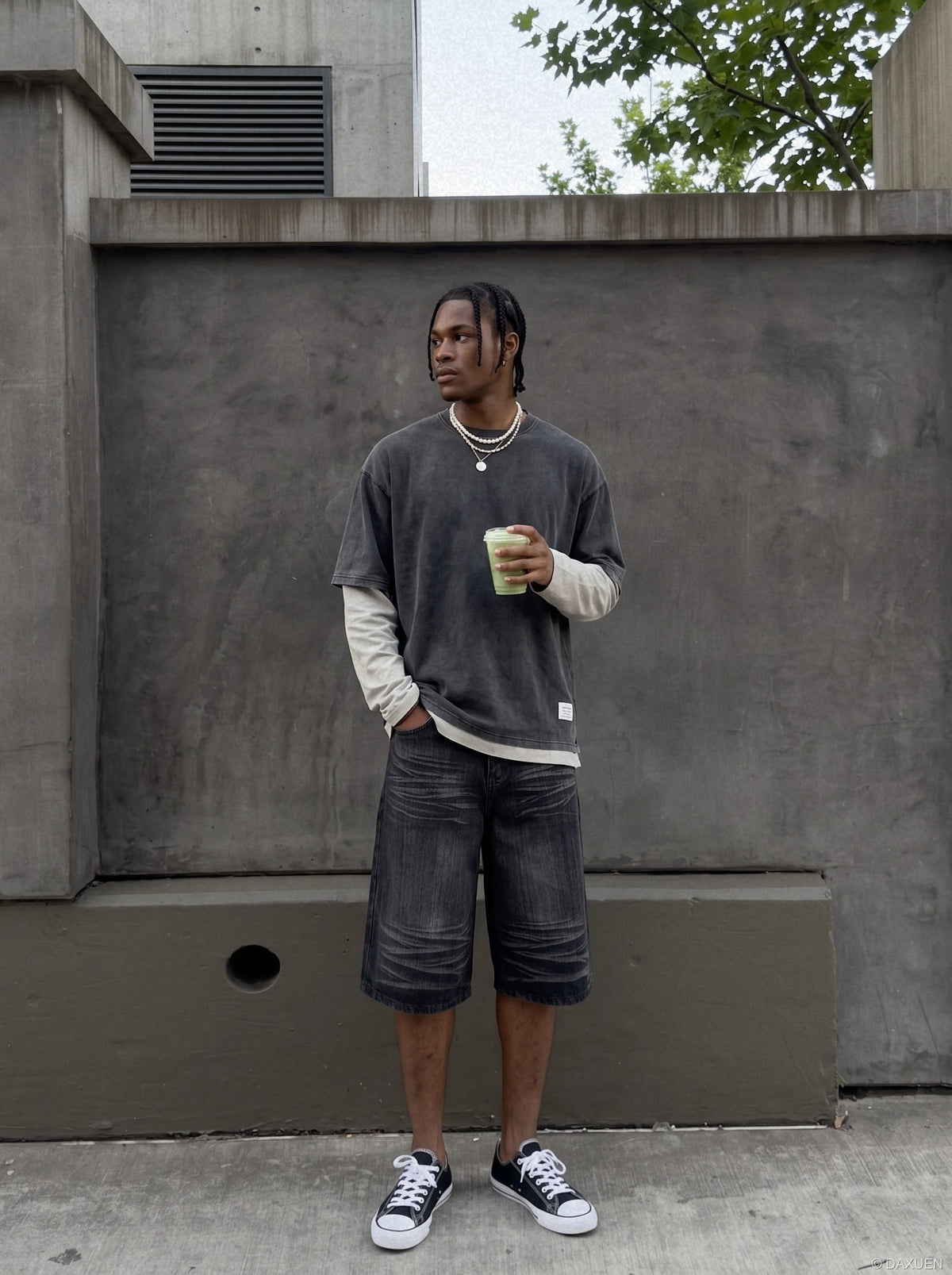 Wide-leg denim shorts in faded black shown on model from back