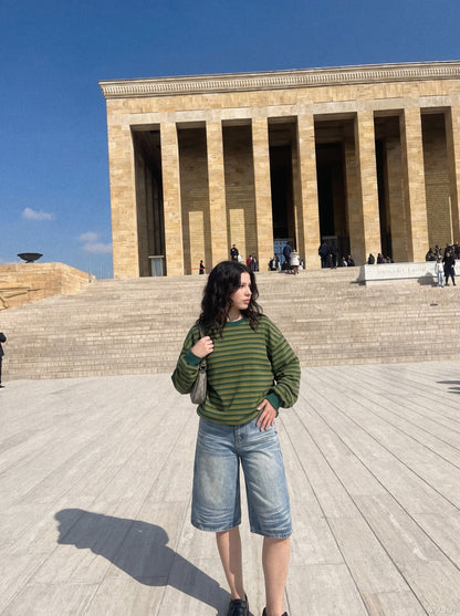 Wide-leg denim shorts in faded black shown on model from front