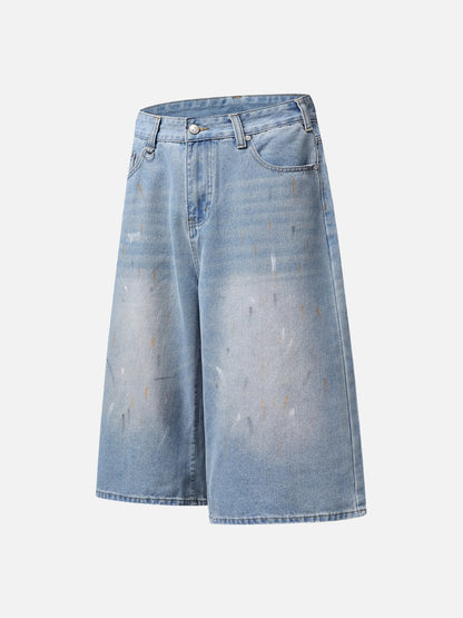 Back pocket detail on faded light blue paint splatter denim shorts