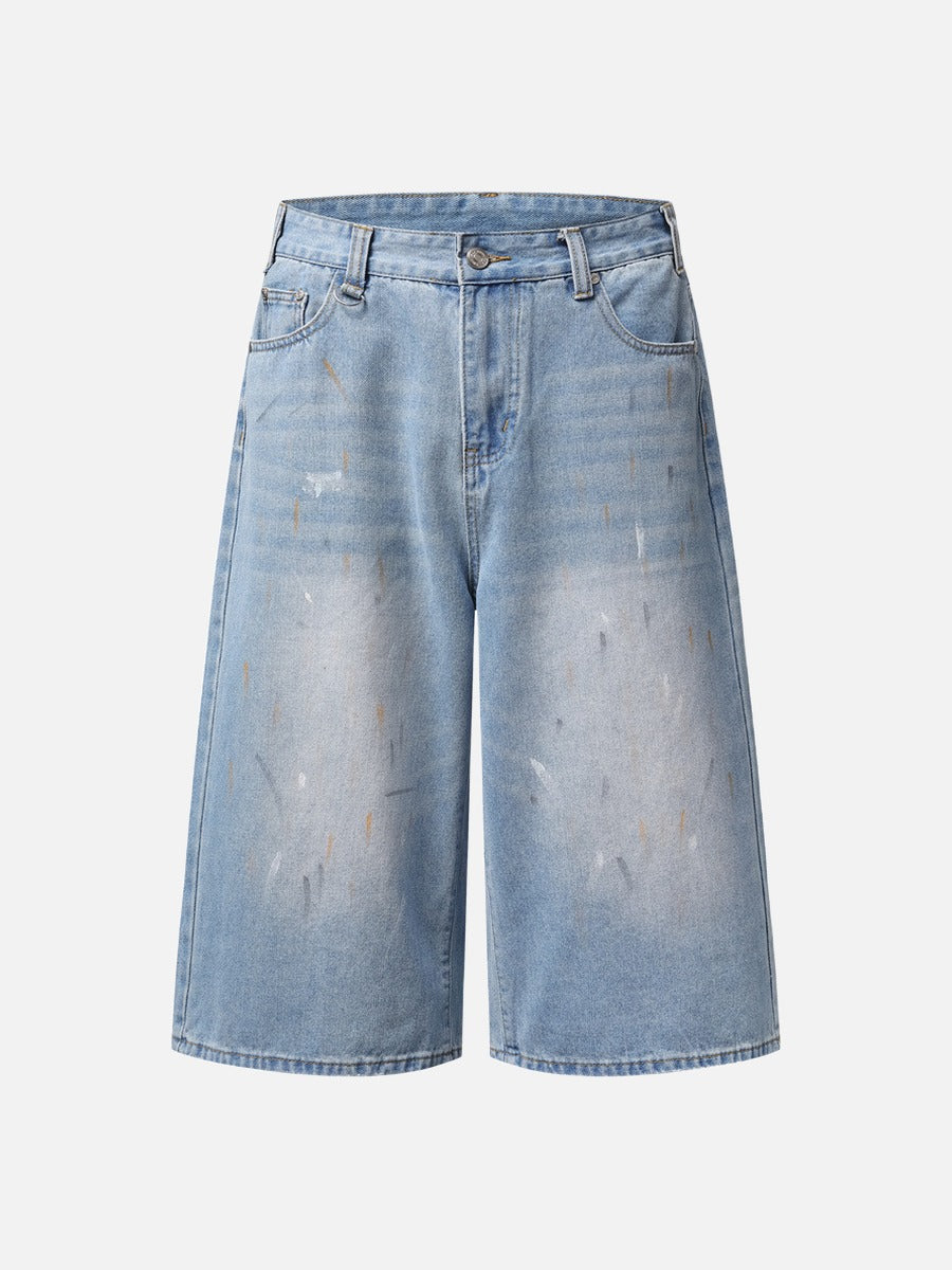 Paint splatter denim culotte shorts in faded light blue shown from the front