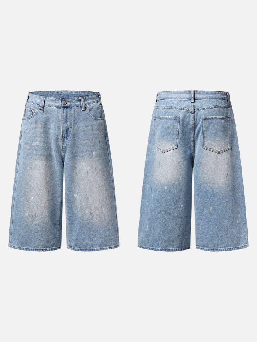 Model wearing paint splatter denim culotte shorts in faded light blue