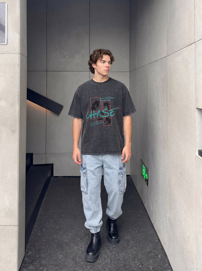 Close-up of faded pixel print on oversized graphic T-shirt