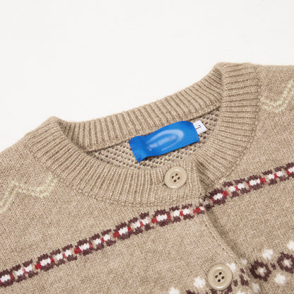 Detail of the knit texture on a beige and grey cardigan.