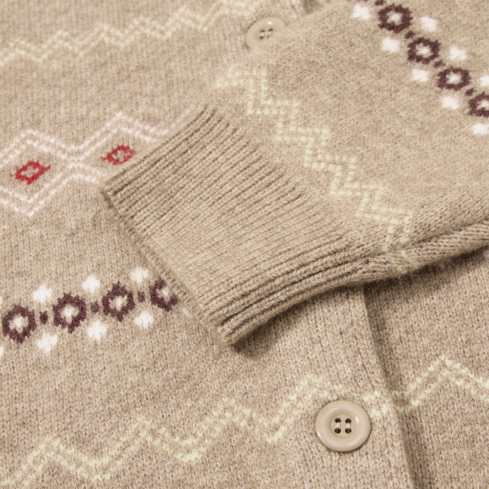 Beige and grey cardigan showing its geometric patterned design.