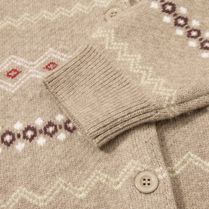 Beige and grey cardigan showing its geometric patterned design.