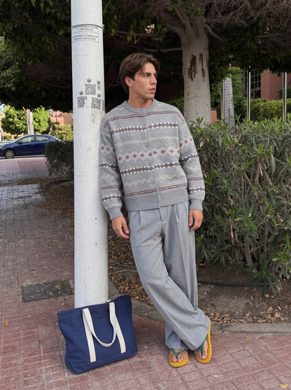 Close-up of the geometric pattern on a beige and grey cardigan.