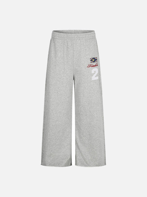 Front view of wide-leg graphic sweatpants with geometric star embroidery