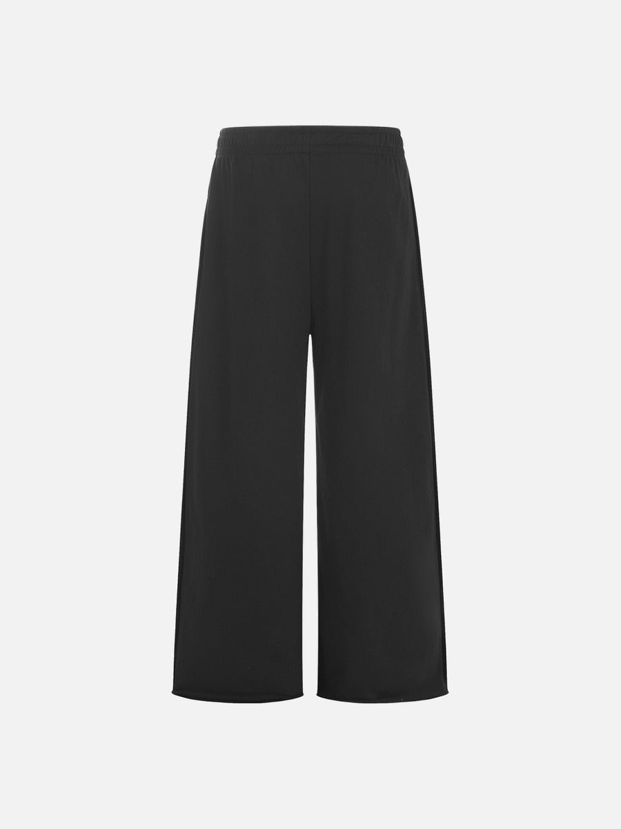 Wide-leg graphic sweatpants styled for a casual streetwear look