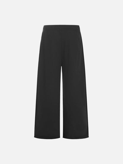 Wide-leg graphic sweatpants styled for a casual streetwear look