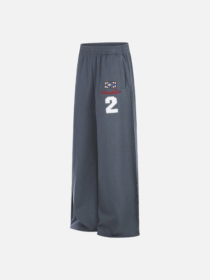 Fabric close-up of graphic sweatpants with embroidered star motif