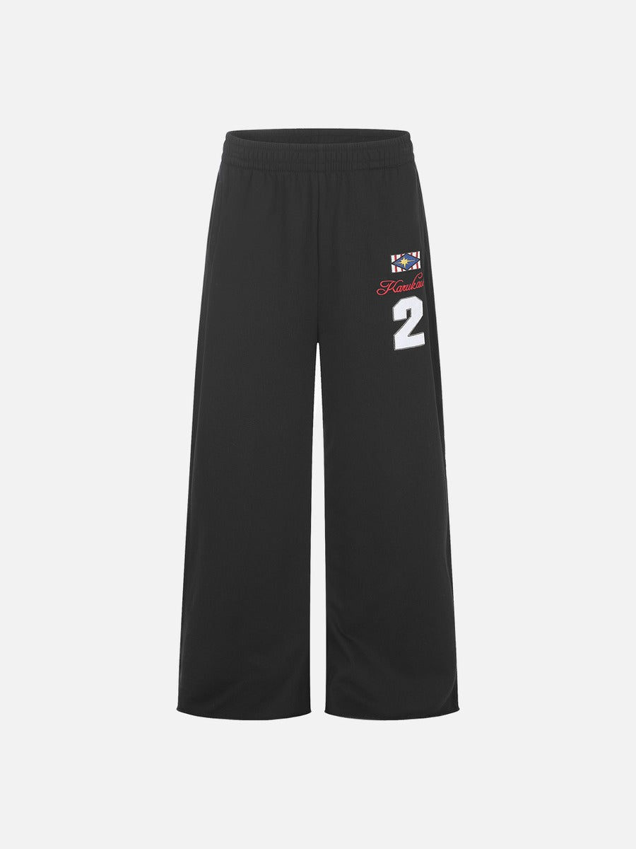 Rear view of wide-leg graphic sweatpants with geometric star embroidery