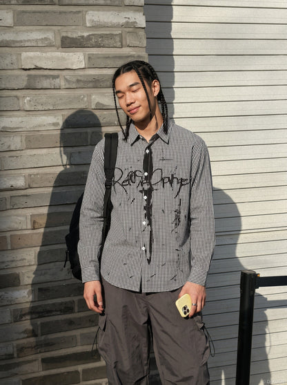 Close-up of the black graphic gingham pattern on the shirt