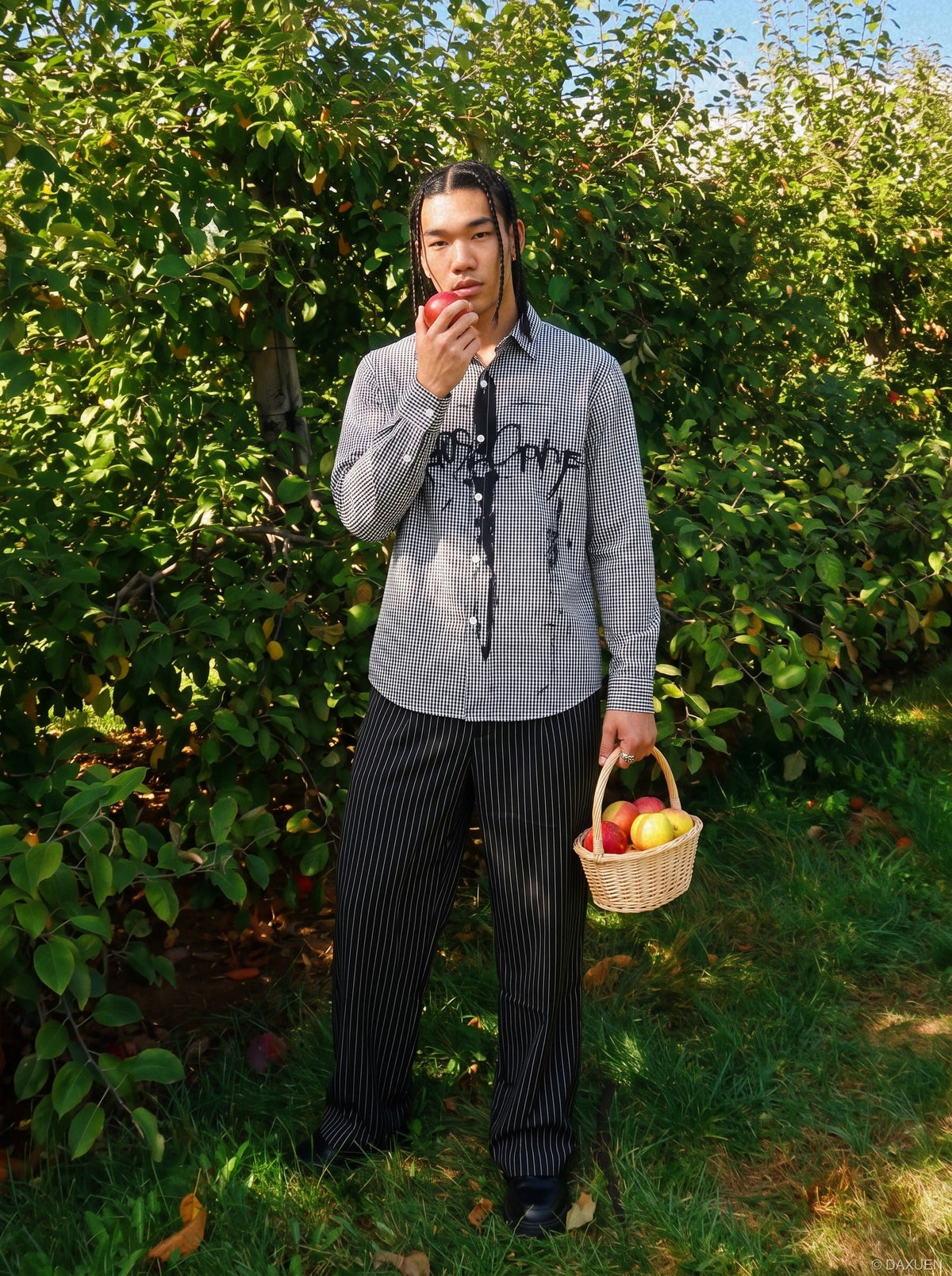 Front view of a black graphic gingham shirt with button fastening