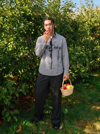 Front view of a black graphic gingham shirt with button fastening