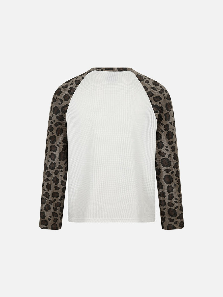 Detailed view of the leopard print fabric and cross graphic design