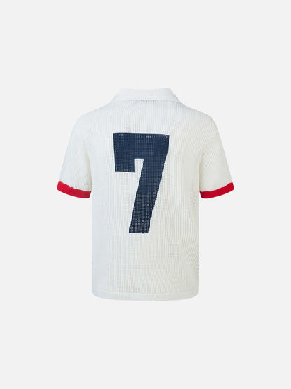 Three-quarter front view of navy, red and white open-knit polo shirt
