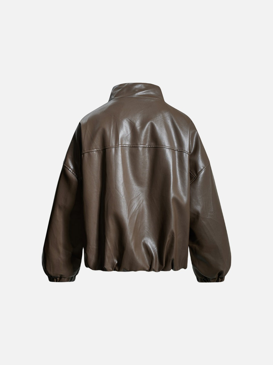 Detail of the front zip fastening on a black faux leather jacket
