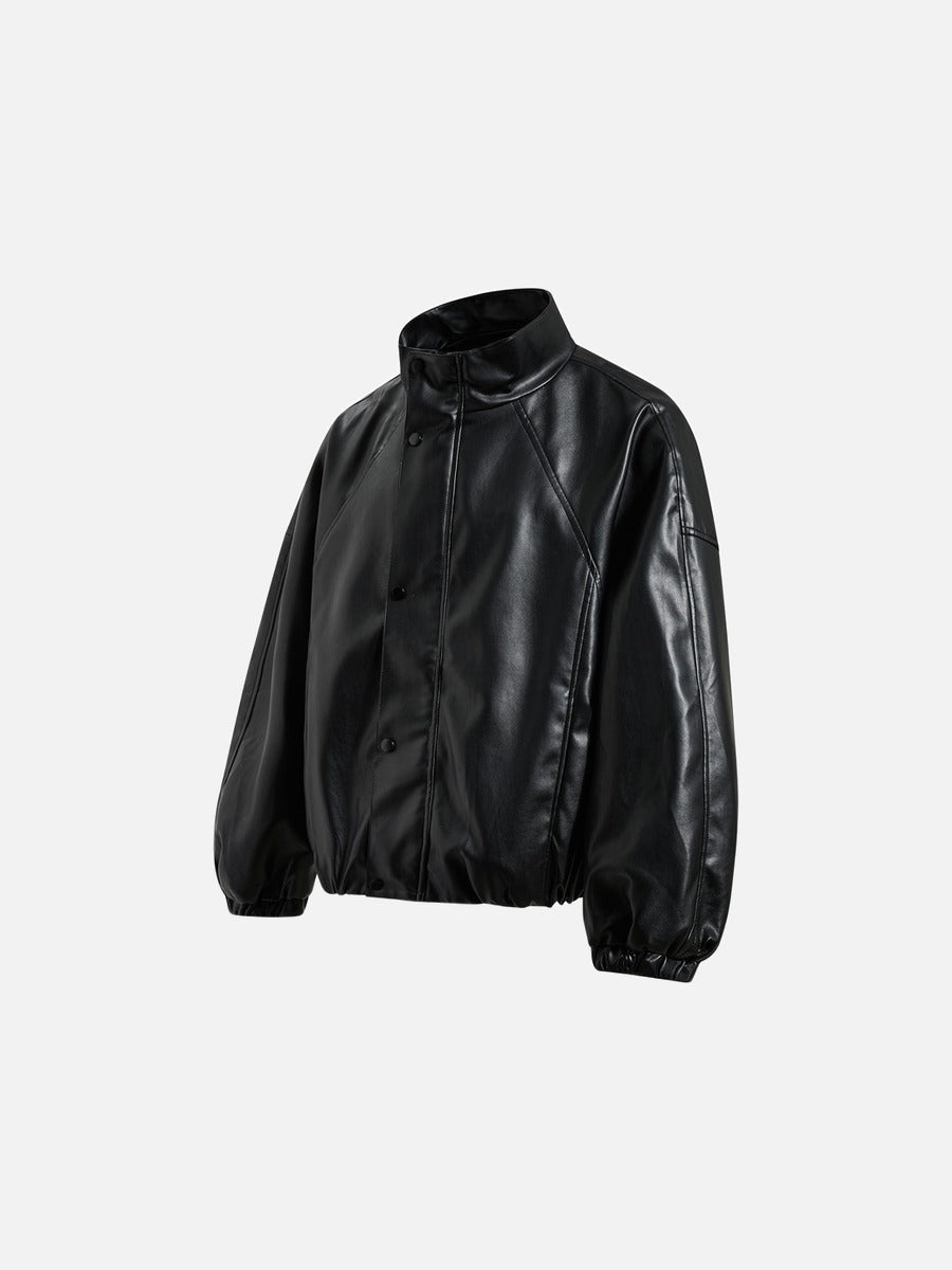 Detail view of the pockets on the black faux leather bomber jacket
