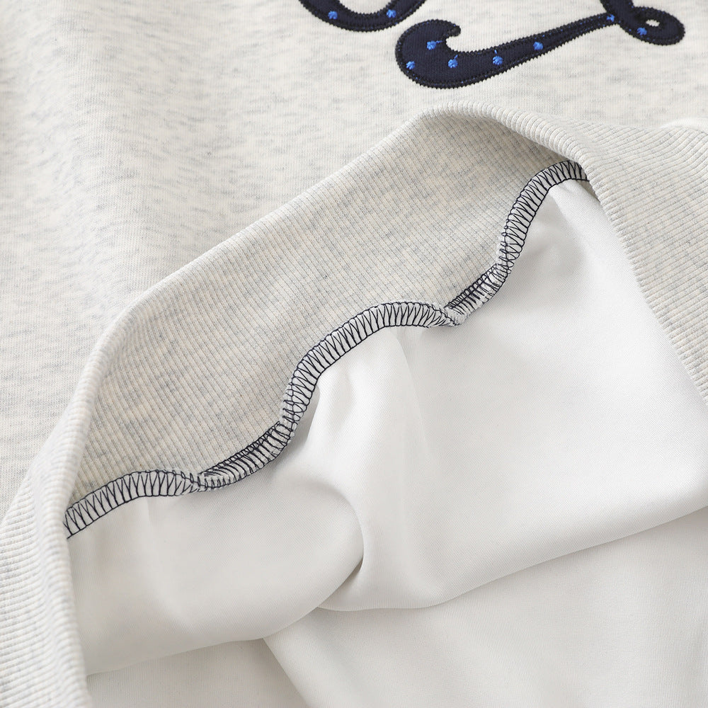Detail of the ribbed cuff on a polka dot raglan hoodie