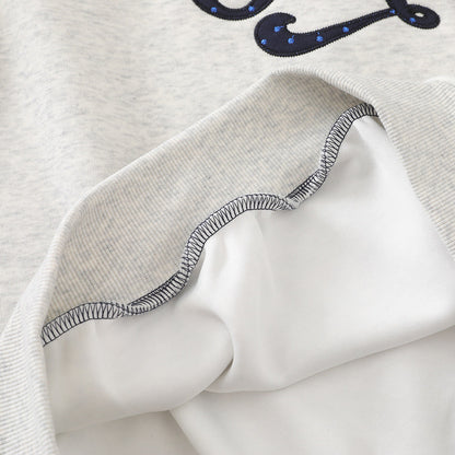 Detail of the ribbed cuff on a polka dot raglan hoodie