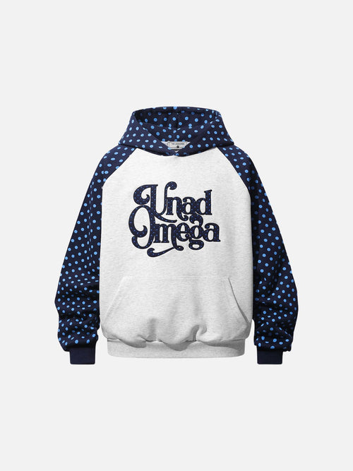 Front view of a polka dot raglan hoodie with graphic script