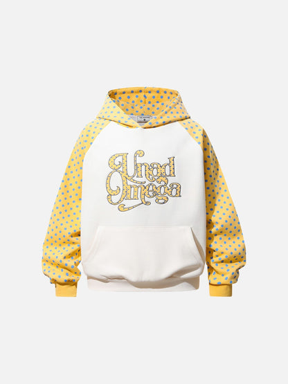 Polka dot hoodie showing its curved raglan sleeves and graphic script