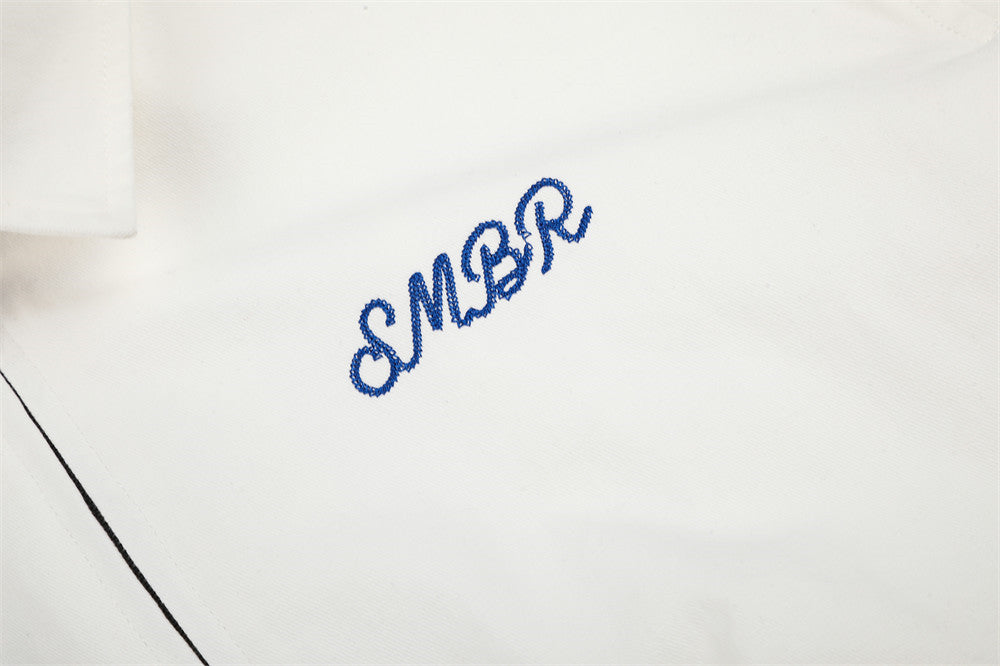 Full view of the white jacket with its playful cow graphic