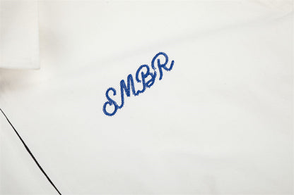 Full view of the white jacket with its playful cow graphic