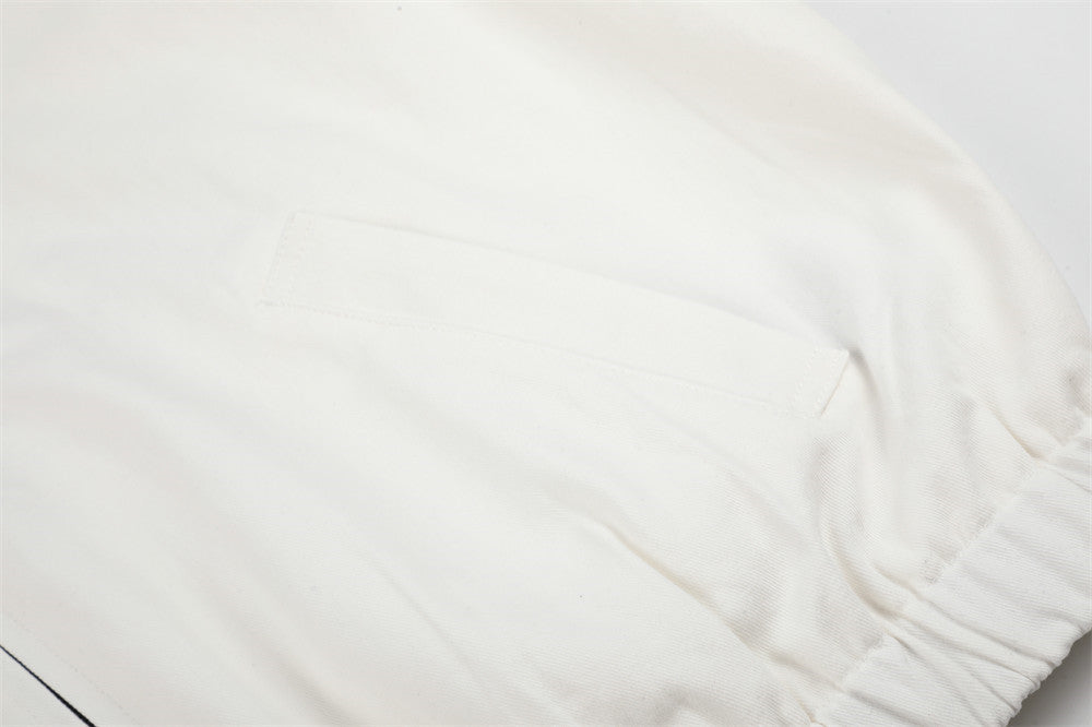 Detailed view of the white embroidered jacket and cow design
