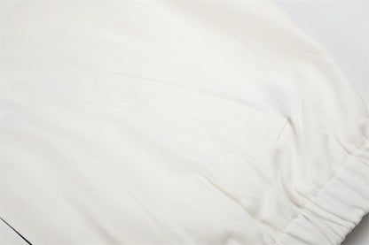 Detailed view of the white embroidered jacket and cow design