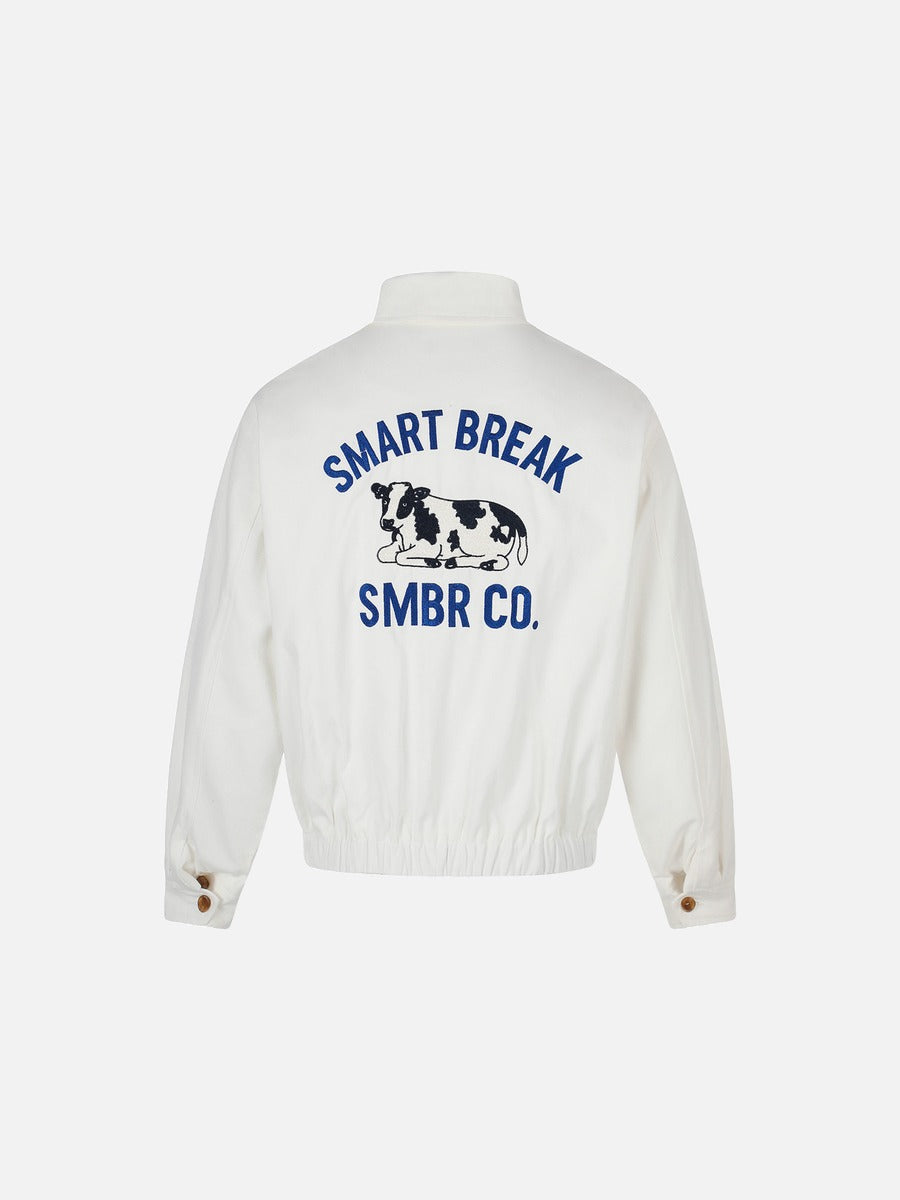 Side view of the white jacket with cow embroidery