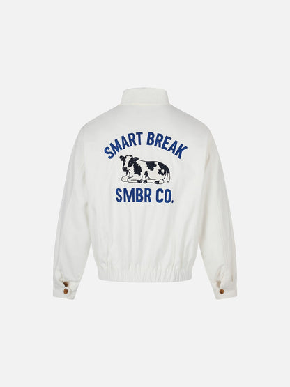 Side view of the white jacket with cow embroidery