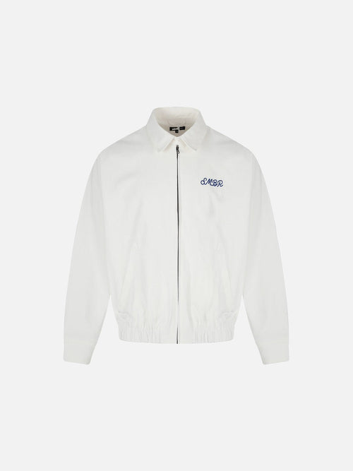 Front view of a white embroidered jacket with a cow graphic