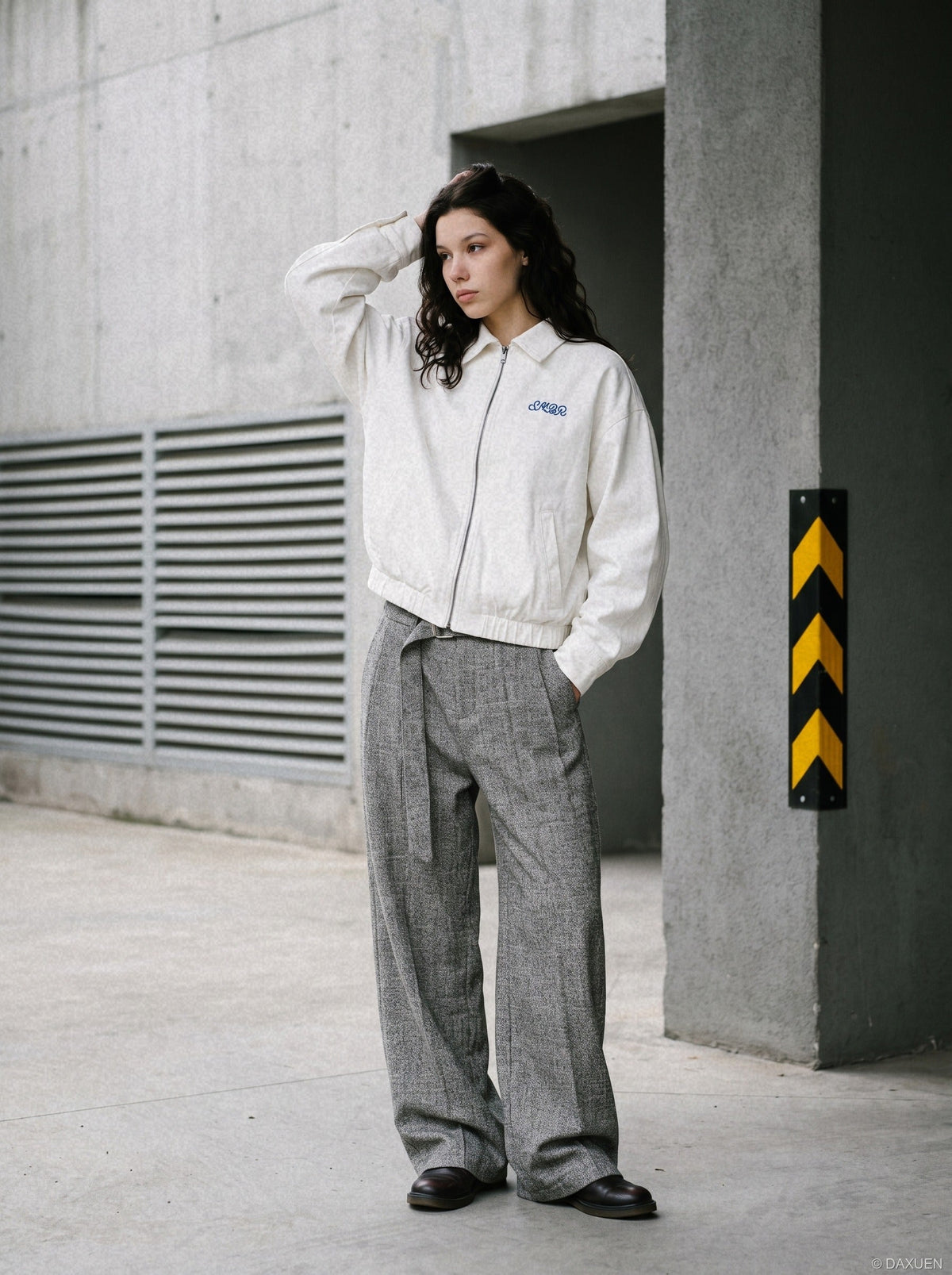 Close-up of the cow graphic embroidered on the white jacket