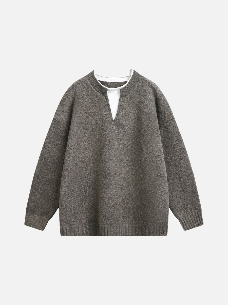 Close-up of the light grey knit texture on the jumper