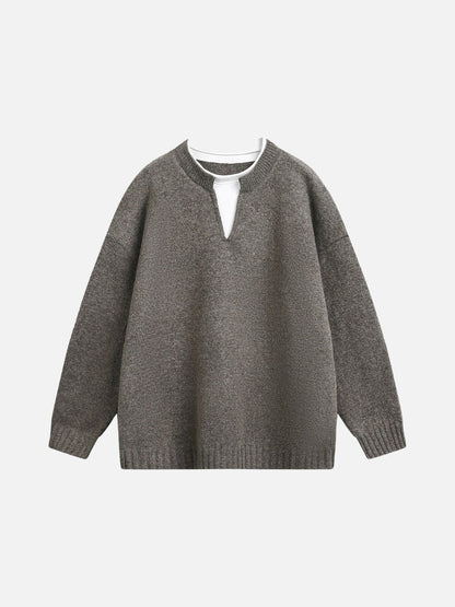 Close-up of the light grey knit texture on the jumper