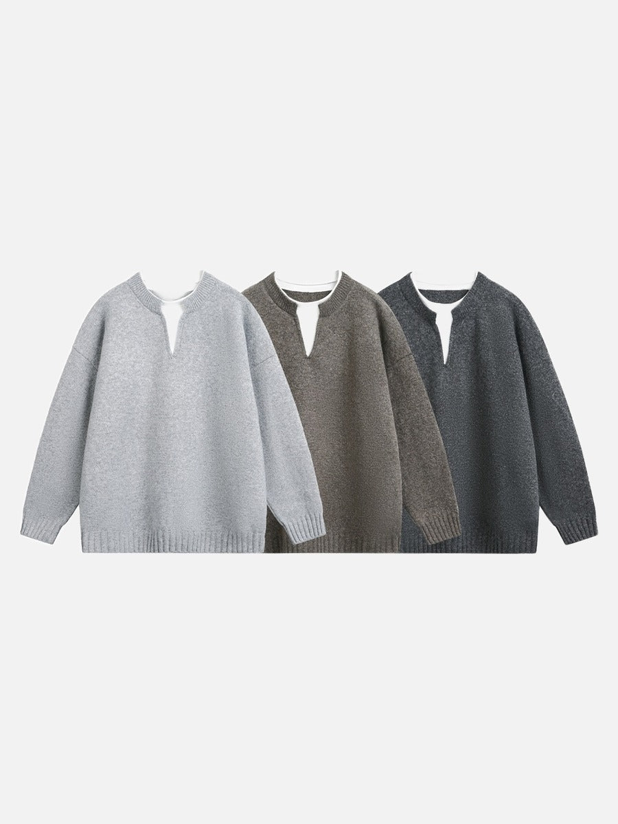 Side view of an oversized light grey knit jumper