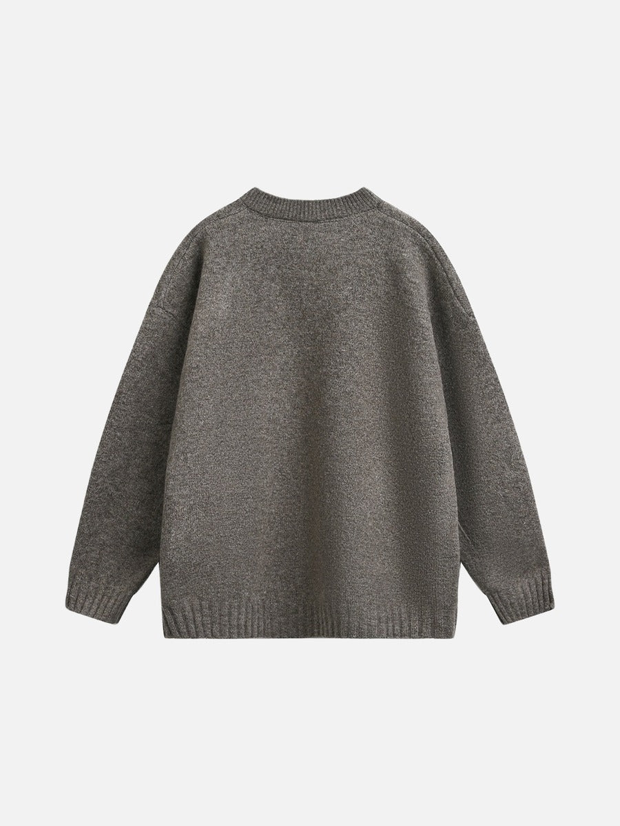 Light grey knit jumper showing its ribbed hem and cuffs